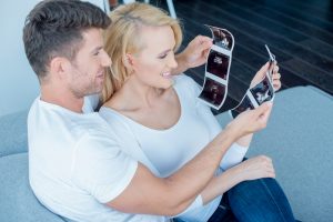 A happy couple looking at images of their pregnancy scan in London