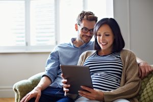 A couple are looking of ultrasound images on a tablet in London
