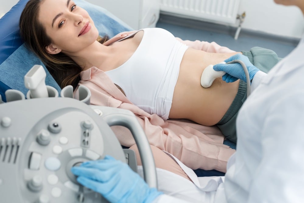 A woman is having a private abdominal scan in a clinic in London, UK